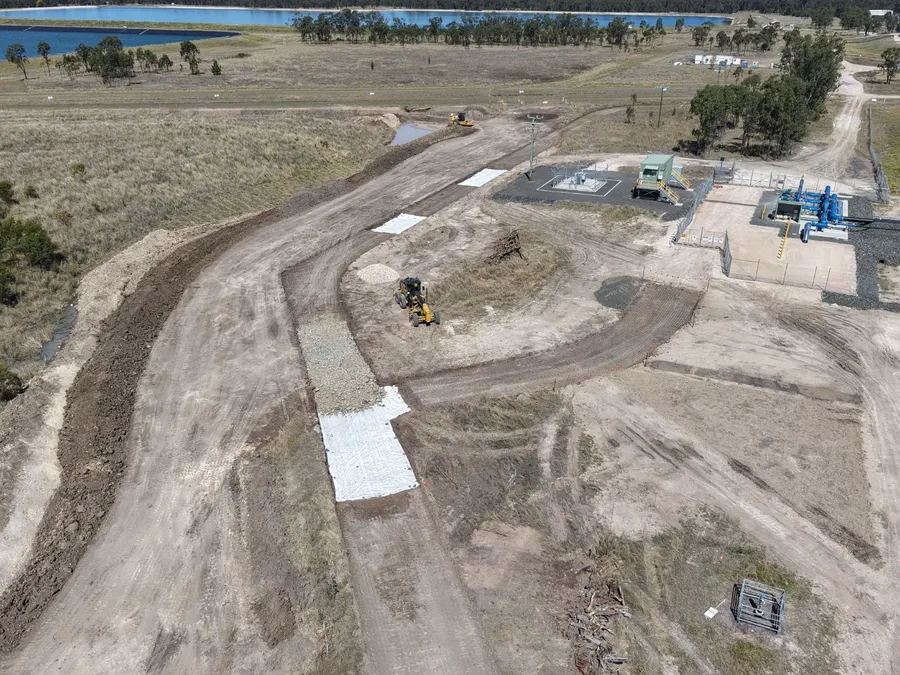 Aerial view of a grader on a road build with geofabric and rock laid